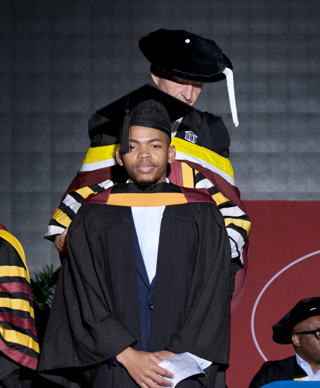 The official hooding ceremony on stage at Boston City Campus